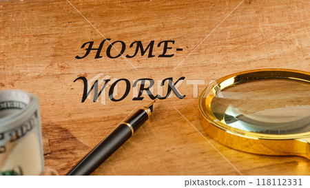 Word HOMEWORK on papyrus in a composition with a fountain pen, a magnifying glass and American dollars 118112331