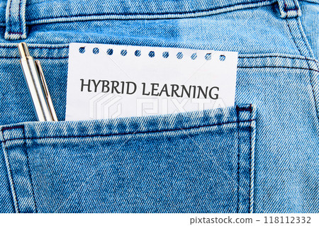 Business, educational and hybrid learning concept, copy space. Concept words HYBRID LEARNING on a piece of paper sticking out of a jeans pocket Business, educational and hybrid learning concept, copy space. Concept words HYBRID LEARNING on a piece of paper sticking out of a jeans pocket 118112332