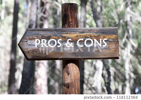 PROS and CONS message on a wooden signpost against a forest background PROS and CONS message on a wooden signpost against a forest background 118112368