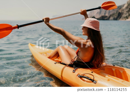 Kayak sea woman. Happy attractive woman with long hair in red swimsuit, swimming on kayak. Summer holiday vacation and travel concept. 118114255
