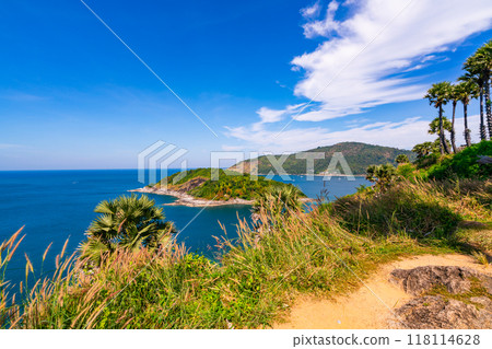 Laem promthep cape with coconut palm trees and grass in the foreground beautiful scenery andaman sea in summer season Phuket thailand Beautiful travel background 118114628