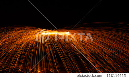 Swing fire Swirl steel wool light photography over the stone with reflex in the water Beautiful light in the sunrise or sunset time, long exposure speed motion style Swing fire Swirl steel wool light photography over the stone with reflex in the water Beautiful light in the sunrise or sunset time, long exposure speed motion style 118114635