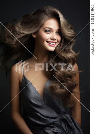 portrait of a young beautiful woman with long curly hair, close-up face, on a dark background, studio beauty photo, style and fashion 118114906