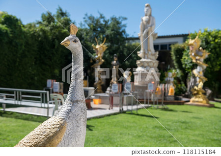 Peacock statue in front of Quan Yin Shrine at wat Khoi in Phetchaburi Peacock statue in front of Quan Yin Shrine at wat Khoi in Phetchaburi 118115184