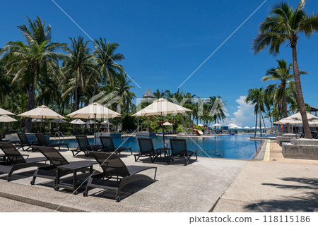 Bedchair at resort pool by sea against blue sky in summer, Hua Hin Bedchair at resort pool by sea against blue sky in summer, Hua Hin 118115186