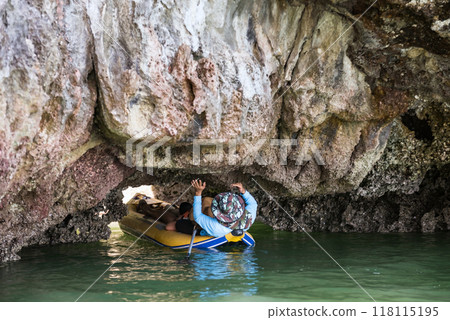 Tourist lying on canoe through Tham Lod or grotto cave, Phang Nga 118115195