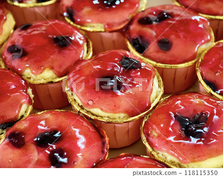 Multiple cupcakes topped with a generous amount of delicious strawberry jelly jam, ready to be served Multiple cupcakes topped with a generous amount of delicious strawberry jelly jam, ready to be served 118115350