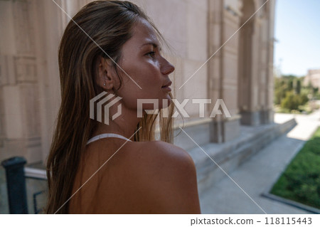 Woman, Building, Portrait - A woman stands outdoors in front of a building. 118115443