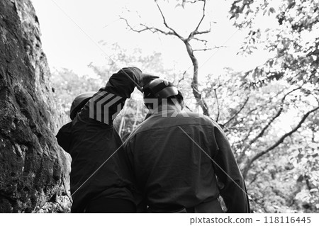 A man preparing for rock climbing on a rock face A man preparing for rock climbing on a rock face 118116445