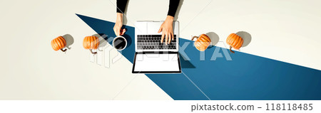 Autumn pumpkins with person using a laptop computer Autumn pumpkins with person using a laptop computer 118118485