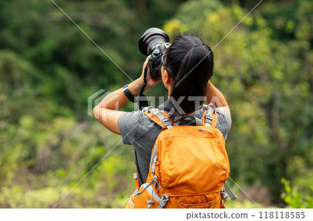 Woman photographer taking pictures in spring mountain Woman photographer taking pictures in spring mountain 118118585