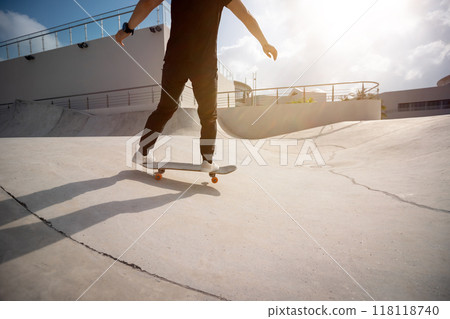 Skateboarder skateboarding at skatepark in city Skateboarder skateboarding at skatepark in city 118118740