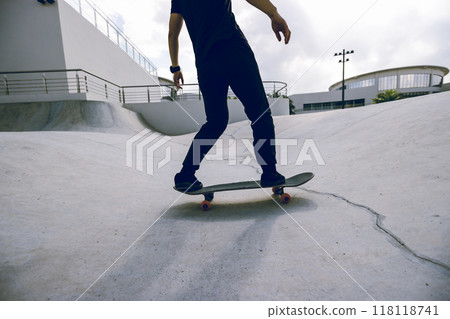 Skateboarder skateboarding at skatepark in city Skateboarder skateboarding at skatepark in city 118118741