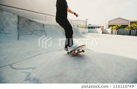 Skateboarder skateboarding at skatepark in city Skateboarder skateboarding at skatepark in city 118118749