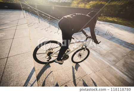Woman free rider riding bike going down city stairs Woman free rider riding bike going down city stairs 118118780