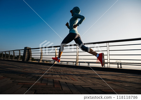 Fitness woman runner running at seaside Fitness woman runner running at seaside 118118786
