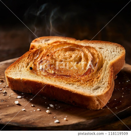 Close-up of steaming slice of toasted bread on wooden surface 118119509