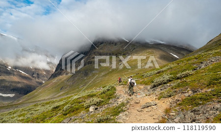 Hikers on Western footpath from Kebnekaise mountain station towards Kebnekaise peak, Lapland, Sweden. Hikers on Western footpath from Kebnekaise mountain station towards Kebnekaise peak, Lapland, Sweden. 118119590