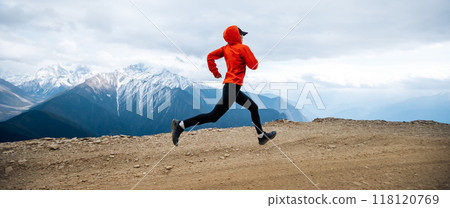 Woman trail runner cross country running at high altitude mountains 118120769