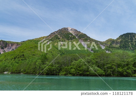 Kamikochi, a scenic mountain spot in Azumi, Matsumoto City, Nagano Prefecture, Japan. Taisho Pond surrounded by fresh greenery and Mount Yake visible in the background 118121178