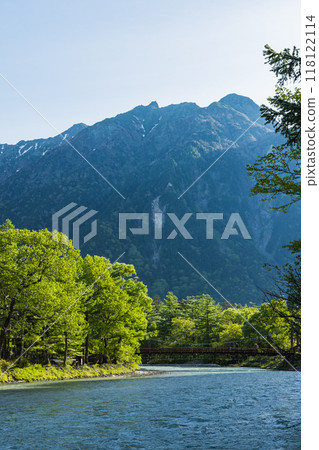 Kamikochi, a scenic mountain spot in Azumi, Matsumoto City, Nagano Prefecture, Japan. Kappa Bridge over the Azusa River with the Hotaka mountain range visible in the background. 118122114
