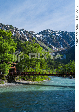 Kamikochi, a scenic mountain spot in Azumi, Matsumoto City, Nagano Prefecture, Japan. Kappa Bridge over the Azusa River with the Hotaka mountain range visible in the background. 118122125