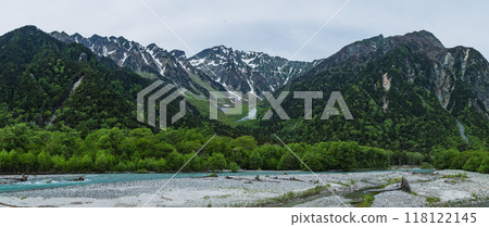 Kamikochi, a scenic mountain spot in Azumi, Matsumoto City, Nagano Prefecture, Japan. The Azusa River surrounded by fresh greenery and the Hotaka mountain range visible in the background. Kamikochi, a scenic mountain spot in Azumi, Matsumoto City, Nagano Prefecture, Japan. The Azusa River surrounded by fresh greenery and the Hotaka mountain range visible in the background. 118122145