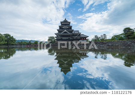 Matsumoto Castle, a national treasure in Matsumoto City, Nagano Prefecture, Japan: The main tower reflected in a mirror on the surface of the inner moat 118122176