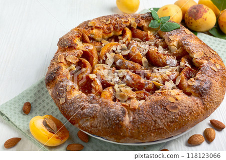 Open pie (galette) with apricots and almonds. Open pie (galette) with apricots and almonds. 118123066
