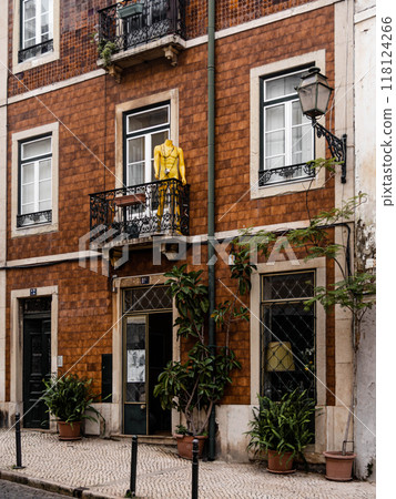 A rustic brick building with black iron balconies 118124266