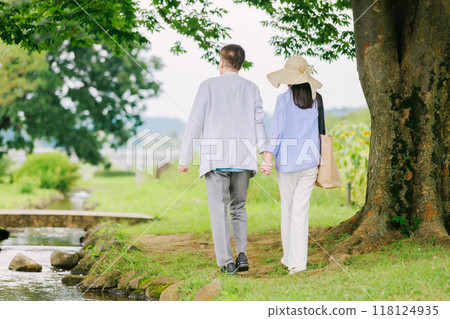 A senior couple strolling through the fresh green park A senior couple strolling through the fresh green park 118124935