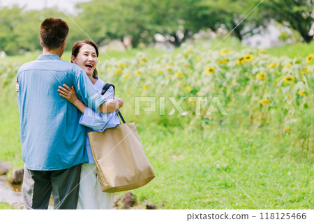 A senior couple strolling through the fresh green park A senior couple strolling through the fresh green park 118125466