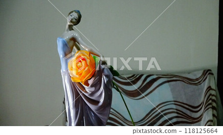 Dancing porcelain doll with orange roses 118125664