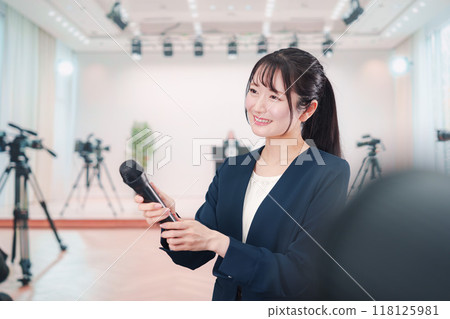 A public relations woman giving an interview in front of the camera 118125981