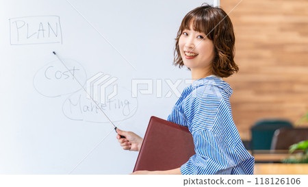 A woman explaining it using a white board A woman explaining it using a white board 118126106