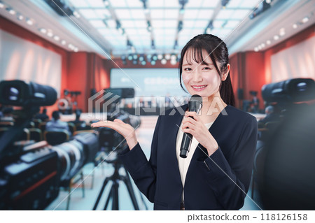 A female reporter reporting from a press conference 118126158