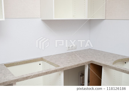 Assembling Kitchen Cabinets. Renovated kitchen interior 118126186