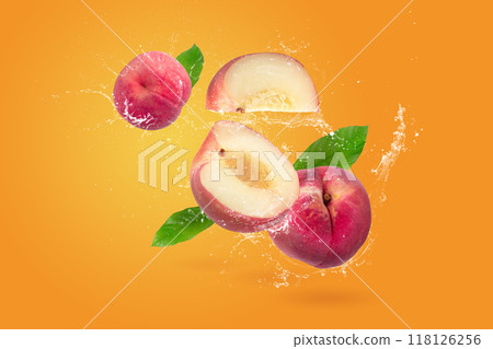 Water splashing on Peach and Peach slice isolater on a orange background Water splashing on Peach and Peach slice isolater on a orange background 118126256