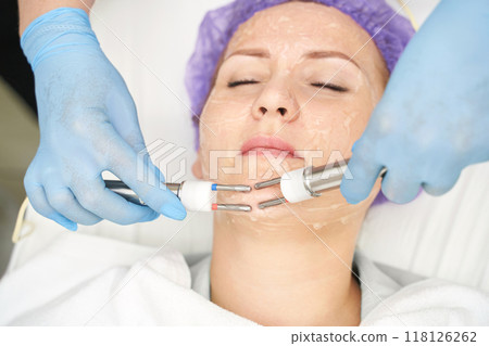 Dermatology anti age treatment. Microcurrent medicine procedure. Woman skin care Dermatology anti age treatment. Microcurrent medicine procedure. Woman skin care 118126262