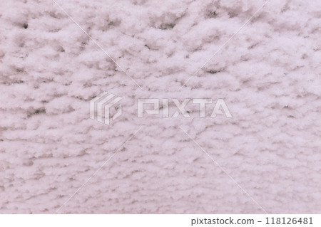 Snow flakes stuck in the form of waves on a white metal sheet. Snow flakes stuck in the form of waves on a white metal sheet. 118126481