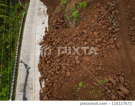 Camiguin Island: Aerial view of mud and rocks blocking the road after rain. Landslides with rocks and soil. Philippines. 118127671