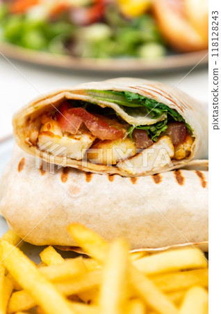 Halloumi wraps with salad and french fries Halloumi wraps with salad and french fries 118128243