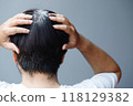 Back view of young people premature gray hair, showing black hoary hair roots on head change to senior old man outdoor. 118129382