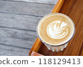 hot coffee cup latte art with spoon Serve ready to drink in cafe on wooden table coffee shop.  Leave copy space empty to write the side text. soft focus. 118129413