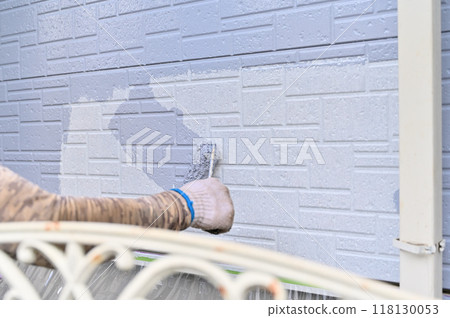 Painter painting with a roller - exterior wall painting work Painter painting with a roller - exterior wall painting work 118130053