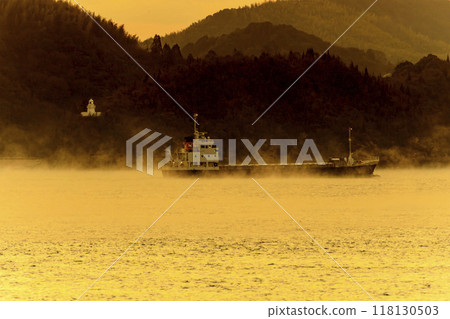 Winter sunrise in Setouchi, the sea with a breeze and cargo ships, lighthouse 118130503
