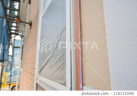 A scene from a house painting project, windows protected, scaffolding A scene from a house painting project, windows protected, scaffolding 118131046