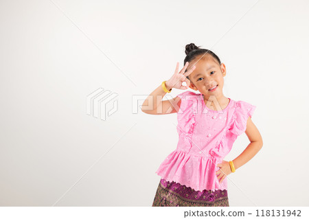 Portrait Thailand kid girl smiling traditional Thai dress costume showcases OK sign with smile, conveying agreement and positivity, studio isolated white background, kindergarten child success sign Portrait Thailand kid girl smiling traditional Thai dress costume showcases OK sign with smile, conveying agreement and positivity, studio isolated white background, kindergarten child success sign 118131942