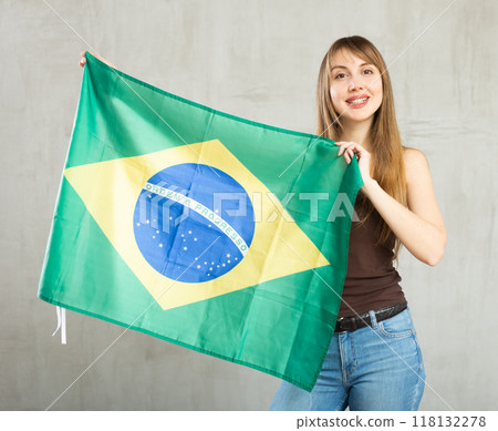 Young cheerful woman holding Brazil flag 118132278