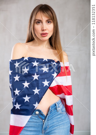 Young pretty woman proudly displaying flag of usa 118132351